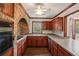 Kitchen with brick archway and wood cabinets at 5622 Williamsburg Dr, Norcross, GA 30093