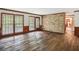 Spacious living room featuring hardwood floors, a brick fireplace, and access to a patio at 5622 Williamsburg Dr, Norcross, GA 30093
