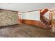 Living room with hardwood floors and brick wall at 5622 Williamsburg Dr, Norcross, GA 30093