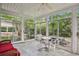 Bright sunroom with tiled floor, wicker furniture, and sliding glass doors at 5622 Williamsburg Dr, Norcross, GA 30093