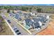 Aerial view showcasing new construction homes, with a pool, driveways, and parking at 929 Hilltop Park Ct, Dacula, GA 30019
