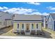 Charming yellow cottage-style home with a welcoming front porch and white columns at 929 Hilltop Park Ct, Dacula, GA 30019