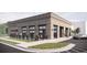 Rendering of a single-story brick commercial building featuring an outdoor patio and ample parking at 929 Hilltop Park Ct, Dacula, GA 30019
