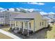 Inviting yellow home with a spacious front porch, perfect for relaxing at 929 Hilltop Park Ct, Dacula, GA 30019