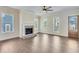 Inviting living room features a fireplace with brick hearth and large windows at 929 Hilltop Park Ct, Dacula, GA 30019