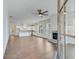 Open concept living area featuring hardwood floors, a fireplace, and seamless access to a modern kitchen at 929 Hilltop Park Ct, Dacula, GA 30019