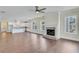 Bright living room with hardwood floors, fireplace, and open floor plan to the kitchen at 929 Hilltop Park Ct, Dacula, GA 30019