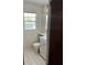 Bathroom with tile floors, white vanity, and single window at 115 Montgomery St, Atlanta, GA 30317