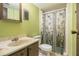 Bathroom with a single sink vanity and a shower with a floral curtain at 112 Camelot Dr, Atlanta, GA 30349