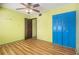 Bedroom with wood-look floors and a double closet with contrasting door colors at 112 Camelot Dr, Atlanta, GA 30349