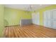 Spacious bedroom with laminate flooring, ceiling fan, and closet space at 112 Camelot Dr, Atlanta, GA 30349