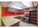 Vintage kitchen featuring old cabinets, laminate countertops, and an older oven with bright red walls at 112 Camelot Dr, Atlanta, GA 30349