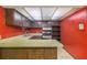 Retro kitchen with older cabinets, light countertops, and older appliances, with bright red walls at 112 Camelot Dr, Atlanta, GA 30349