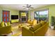 Bright living room features a stone fireplace, wood floors, and sliding glass door to the balcony at 112 Camelot Dr, Atlanta, GA 30349