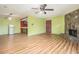 Open-plan living area with a stone fireplace, view of the kitchen, and wood flooring at 112 Camelot Dr, Atlanta, GA 30349