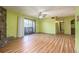 Living room with a stone fireplace, sliding glass door leading to the balcony, and wood flooring at 112 Camelot Dr, Atlanta, GA 30349