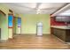 Open-plan living area with wood flooring, a kitchen, and brightly-painted red accents at 112 Camelot Dr, Atlanta, GA 30349