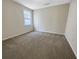 This bedroom has soft carpeting and natural light from the window at 4337 Ben Hill Rd, Atlanta, GA 30349