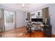 Bedroom with hardwood floors, natural light, ceiling fan, and functional desk and chair setup at 2785 Toney Dr, Decatur, GA 30032