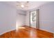 Well-lit bedroom with wood floors, neutral walls, ceiling fan, and a bright window view at 2785 Toney Dr, Decatur, GA 30032