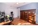 Bedroom with hardwood floors, ceiling fan, natural light, and large wood bookcase for storage at 2785 Toney Dr, Decatur, GA 30032