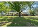 Brick ranch home with a large grassy front yard and mature trees at 2785 Toney Dr, Decatur, GA 30032