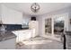 Bright kitchen featuring white cabinetry, granite countertops, blue tile backsplash, and sliding glass doors to the deck at 2785 Toney Dr, Decatur, GA 30032