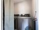 Laundry room with gray, front-loading washer and dryer units at 2785 Toney Dr, Decatur, GA 30032