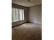 Spacious bedroom with carpeted floor and window with blinds at 17 Fair Haven Se Way, Smyrna, GA 30080