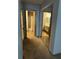 Hallway with mirrored closet doors and access to two bathrooms at 17 Fair Haven Se Way, Smyrna, GA 30080