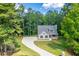 House nestled in a wooded area with a long driveway at 939 Jean Ct, Covington, GA 30014