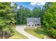 House nestled in a wooded lot with a long driveway at 939 Jean Ct, Covington, GA 30014