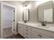 Bathroom with double vanity, quartz countertop and walk-in closet at 939 Jean Ct, Covington, GA 30014