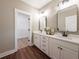 Double vanity bathroom with walk-in closet and white cabinets at 939 Jean Ct, Covington, GA 30014