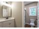 Modern bathroom with single vanity, shower, and toilet at 939 Jean Ct, Covington, GA 30014