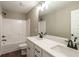 Bathroom with double vanity, white cabinets, and a shower at 939 Jean Ct, Covington, GA 30014