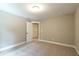 Bright bedroom with carpeted floors and an open door at 939 Jean Ct, Covington, GA 30014