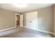 Spacious bedroom with double doors and carpet flooring at 939 Jean Ct, Covington, GA 30014