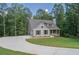 Gray siding house with a large driveway and green lawn at 939 Jean Ct, Covington, GA 30014