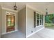 Inviting front porch with a wooden door and dark shutters at 939 Jean Ct, Covington, GA 30014