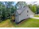 Two-story house with gray siding, deck, and attached garage, nestled in a wooded area at 939 Jean Ct, Covington, GA 30014