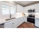 White kitchen with stainless steel appliances and subway tile backsplash at 939 Jean Ct, Covington, GA 30014