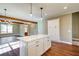 Kitchen island with white cabinets and a view into the living room at 939 Jean Ct, Covington, GA 30014