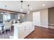 Modern kitchen with white cabinetry, island, and hardwood floors at 939 Jean Ct, Covington, GA 30014