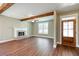 Spacious living room with hardwood floors, fireplace and exposed beams at 939 Jean Ct, Covington, GA 30014