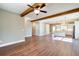 Open living room with hardwood floors, exposed beams, and a view into the kitchen at 939 Jean Ct, Covington, GA 30014