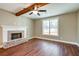 Living room with hardwood floors, a brick fireplace, and exposed beams at 939 Jean Ct, Covington, GA 30014