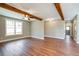 Living room featuring hardwood floors, high ceilings, and exposed beams at 939 Jean Ct, Covington, GA 30014