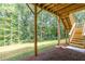 Unfinished lower patio with wooden stairs leading to backyard and wooded view at 939 Jean Ct, Covington, GA 30014