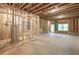 Unfinished basement with framed walls and a window at 939 Jean Ct, Covington, GA 30014